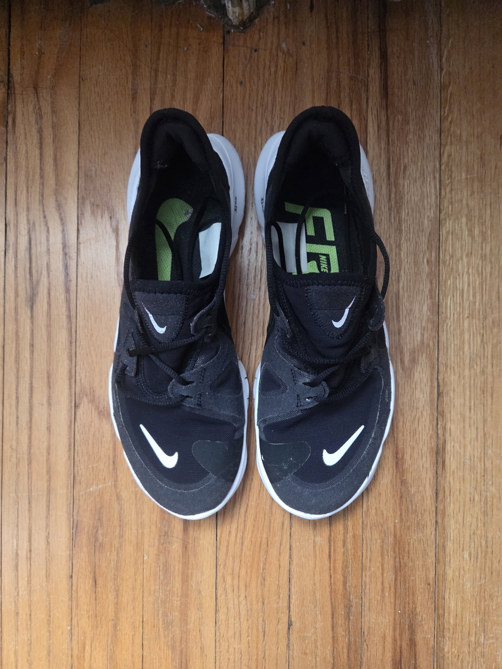 Women's Nike Free Black and White Running Shoes with Green and White Accents